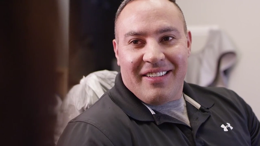 Anthony smiling while wearing a black shirt.