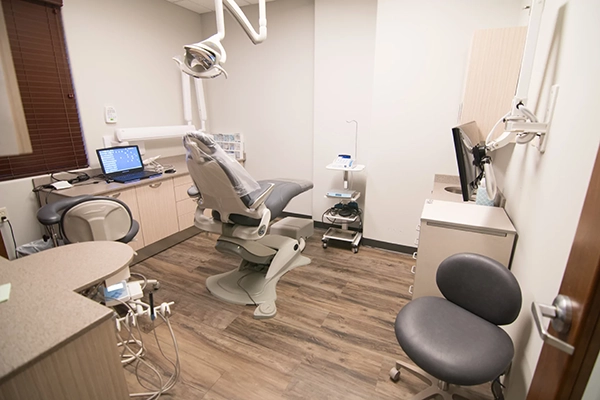 An exam room with a dental chair and equipment.