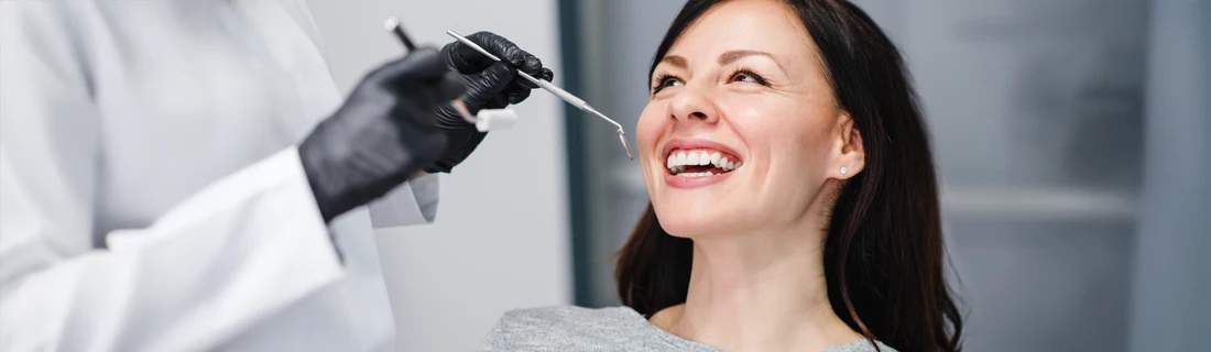 Dentist Avondale AZ General Dentistry A woman with dark hair smiling during an exam.