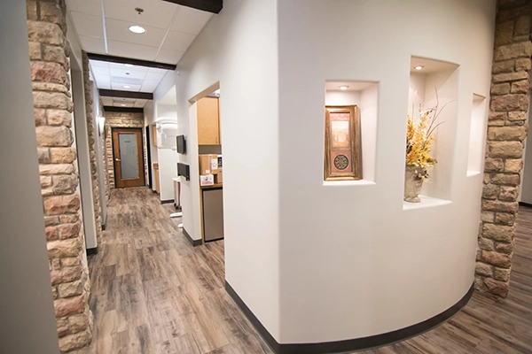 A view of the hallway. The hallway has stone walls.
