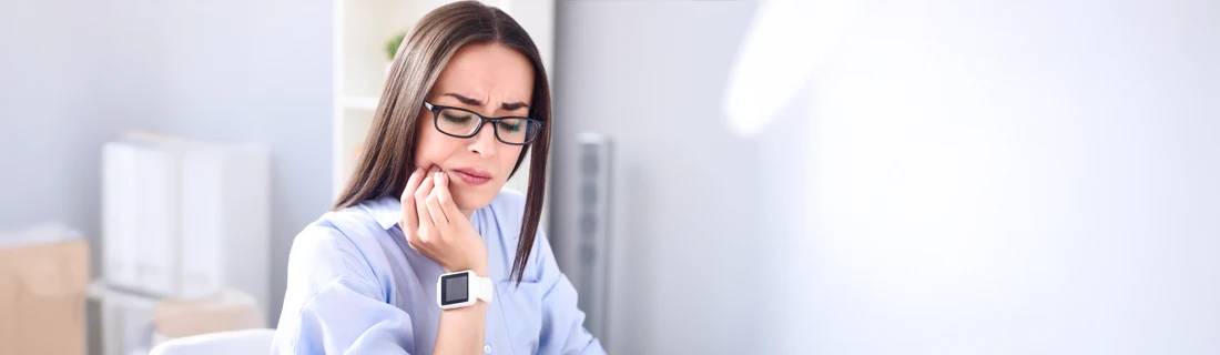 Dentist Avondale AZ Root Canal A woman holding her jaw in pain.
