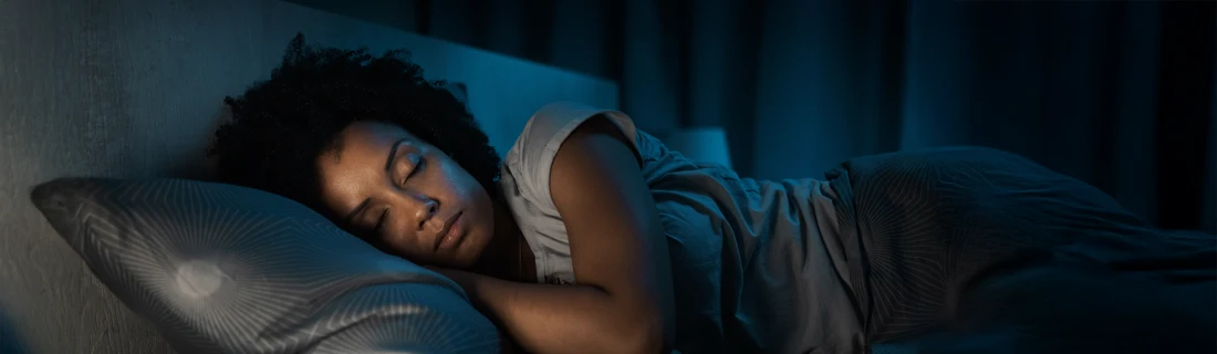 Dentist Avondale AZ Sleep Apnea A woman laying in bed sleeping.