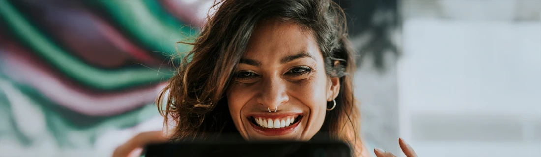 Dentist Avondale AZ Smiling Woman A woman smiling at her phone.