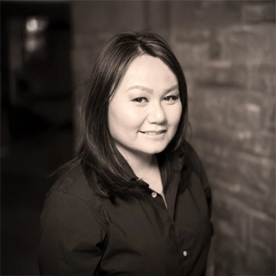 Thihan C. Phan smiling in a black shirt.