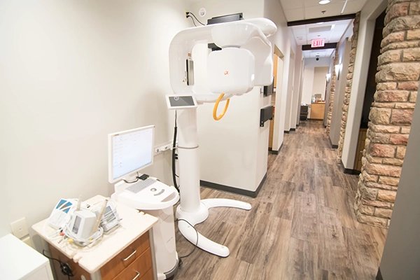 The X-Ray machine in a hallway with stone walls.