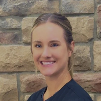 A headshot photo of Ashley, a dental hygienist